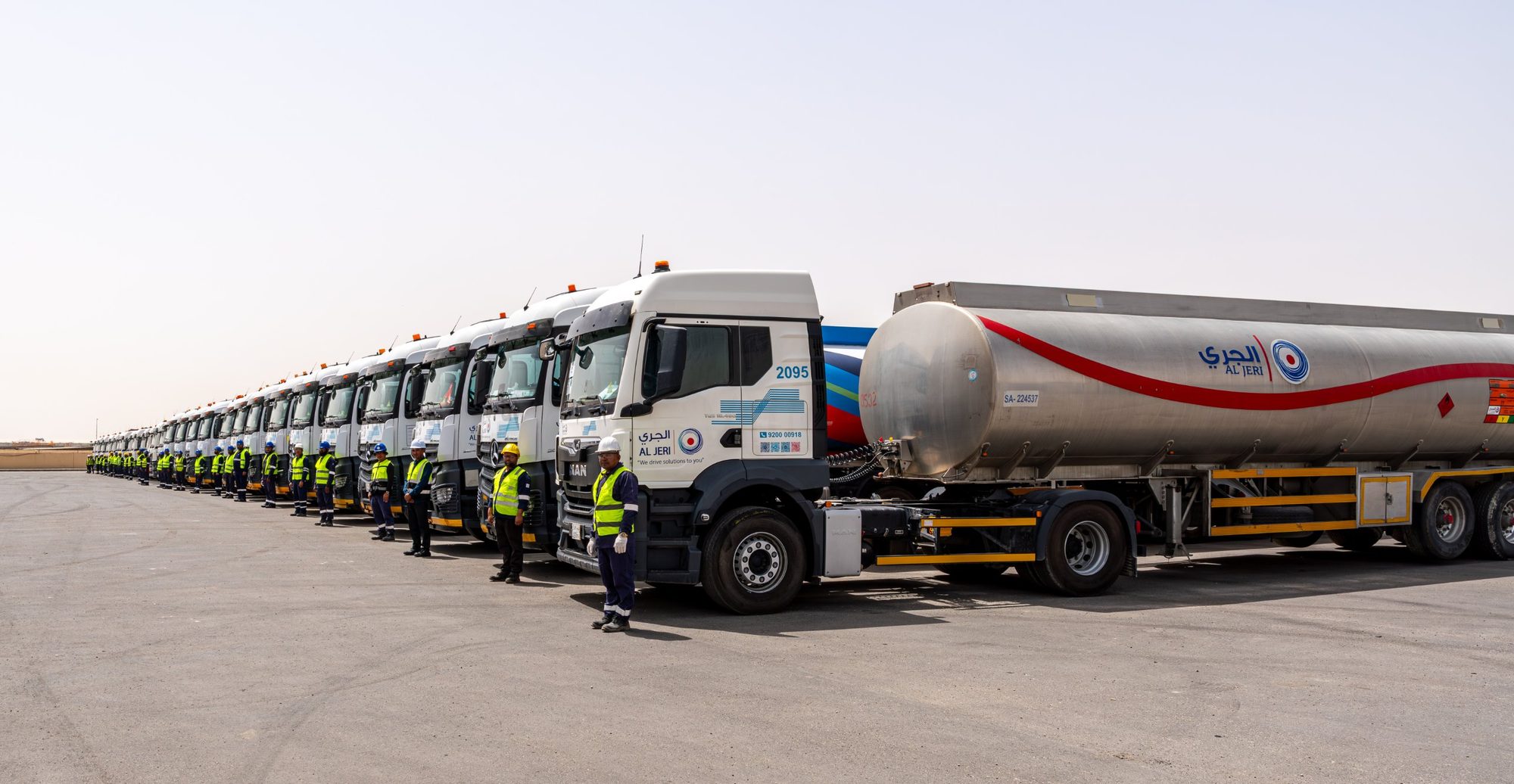 A line of Al Jeri tanker trucks with their drivers